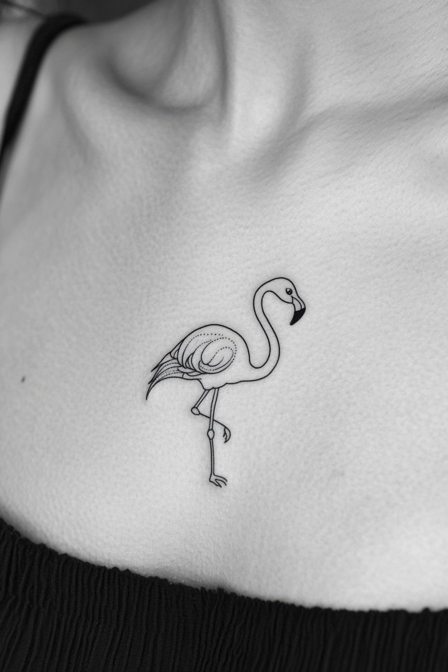 A minimalist flamingo tattoo on the left side of a f